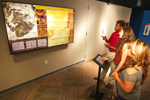 Students examine new display at the Bradbury Museum