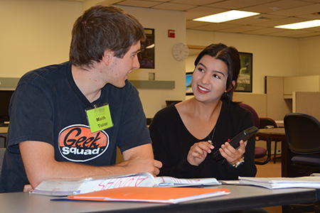 Biochemistry sophomore Karly Ortiz, right, works with ARMAS math tutor and senior math major Jacob Kelly to calculate a logarithm in the ARMAS Center. Ortiz is from Las Vegas, New Mexico and Kelly is from Ojo Feliz, New Mexico. Photo: Margaret McKinney/Highlands University