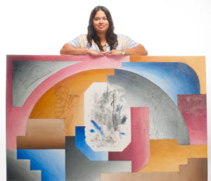 Photo Rick Loffredo/Highlands University Highlands student Dyna Amaya-Lainez stands with her painting that replaces the missing mural from Ilfeld Auditorium. A plaque with the quote “Readeth maketh a full man” will be affixed to the center of the painting. 