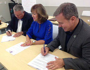 Sam Minner, Barbara Damron and Richard Bailey sign an MOU