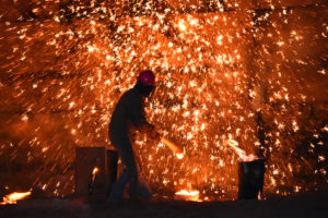 Photo of molten metal sparkling in the night