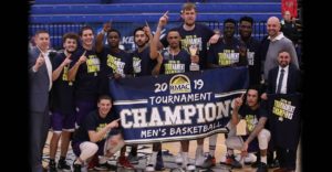 photo of men's basketball team with champions sign