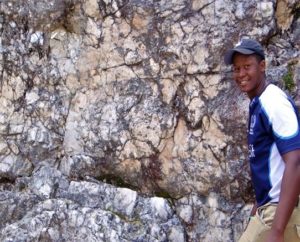 Photo of student at rock wall.