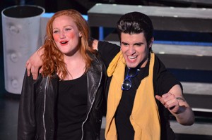 two people singing on stage