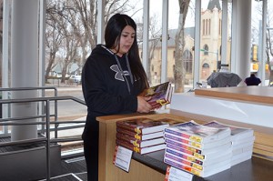 Photo of person stacking books
