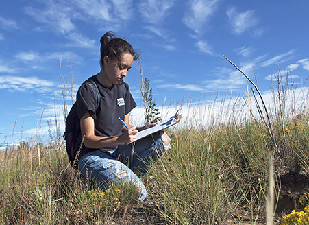 Conservation management student Elisa Abeyta works in the field.