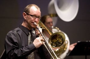 A man plays the trombone