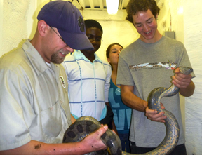 students and professor examine snake