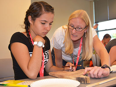 Professor Sara Brown works with a student.