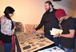 Margaret McKinney/Highlands University Media arts student Andrew LaPointe, center, talks about his Seabury Fellowship project, a book titled How to Cook an Octopus, April 29. From the left are media arts graduate students Behshad Yekkeh and Rahul Patle. 