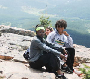 students photographed on rocks