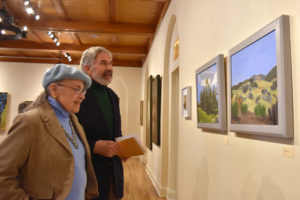 photo of people looking at painting