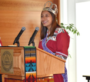 Lenaya Martínez speaking at the podium