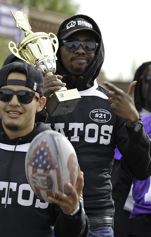 Members of Highlands’ Vatos rugby team march in the 2016 homecoming parade.