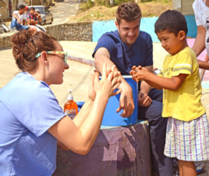 two students providing medical care