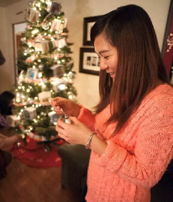 photo of student decorating a holiday tree