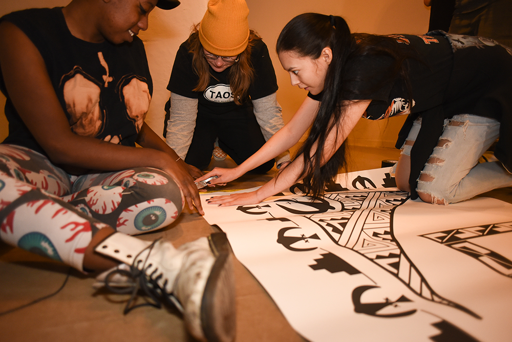 Photo of three students working on floor template.