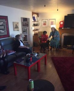 Photo of three seated women chatting