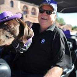 Photo of Bella the dog with President Minner in the parade car.
