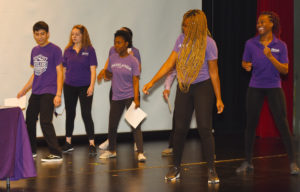 Image of Cutline: Highlands University students participating in a production for the 2019 Power of Service kickoff in Ilfeld Auditorium.  