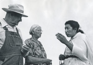 Image of Maria Moreno speaking with a couple.
