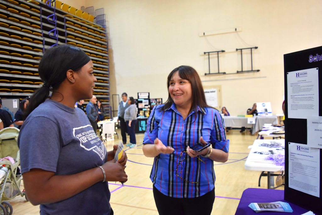 Photo of counselor and student chatting at career fair.