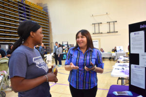 Photo of counselor and student chatting at career fair.