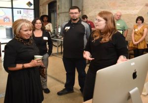 NM governor talking to student in front of computer. 