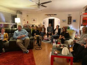 People sitting in a living room at the presidents home.