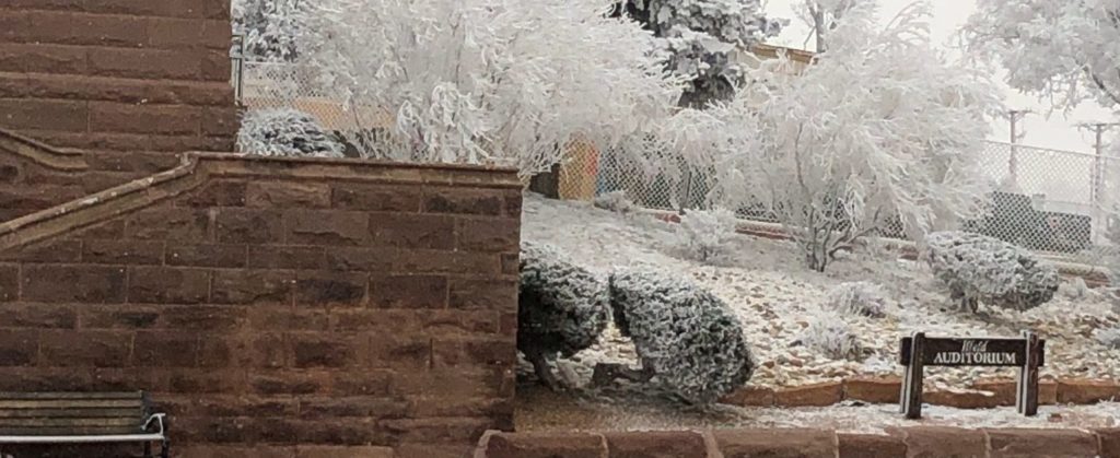 Snowy scene outside Ilfeld Auditorium.