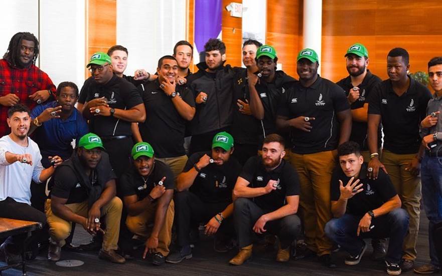 Photo of the Vatos showing off their rings.