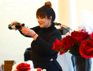 Photo of Sara Jo Mathews from Borracho's Craft Booze and Brews pouring wine for attendees at last year’s “Love and War” chocolate event.