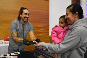 Isaac Sandoval serves dessert at "Love and War" event.