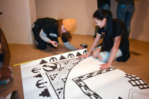 Media arts student photo at work on Jemez Historic Site visitor center. 