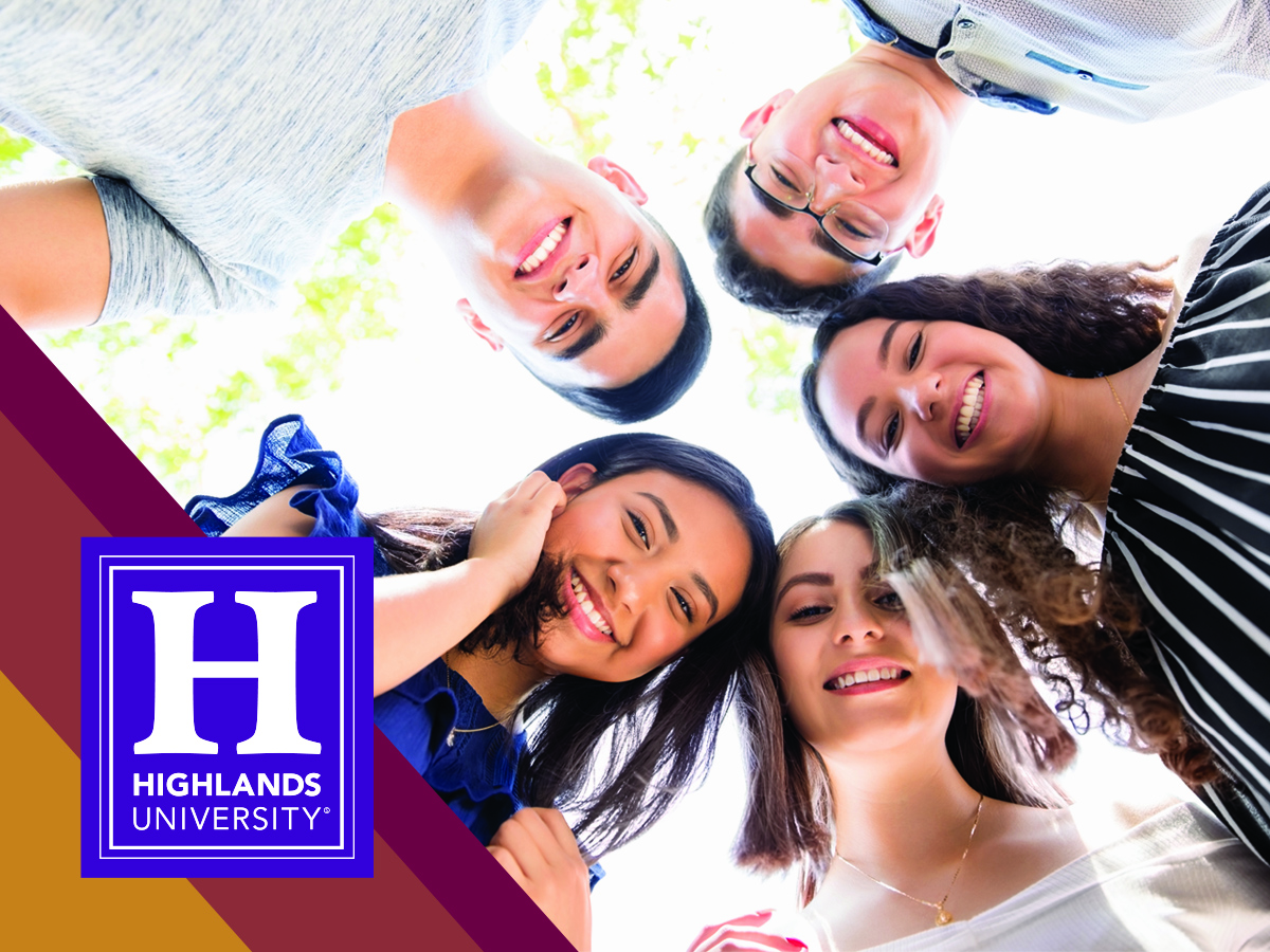 Image of smiling students looking down at camera