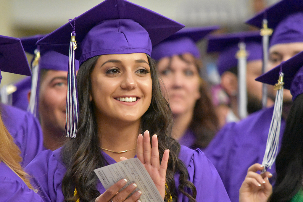 photo of graduate applauding at Commencement