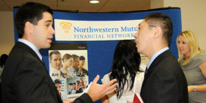 Photo of recruiter and student chatting at career fair