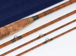 Photo of three bamboo rods and an oar