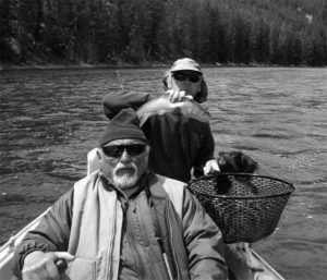 Author Jim Harrison, a friend and a dog in a small fishing boat