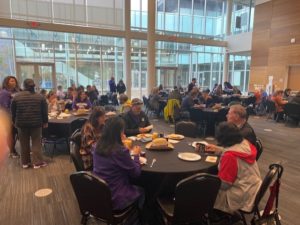 Photo of people enjoying coffee and snacks in the SUB ballroom.