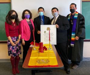 Two students and three professors wearing masks pose with Sigma Delta Pi charter for inaugural induction ceremony