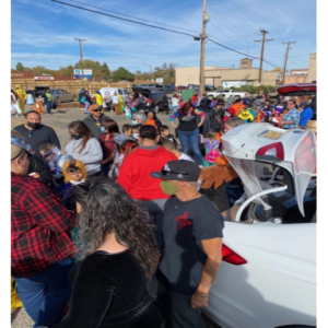 Photo of a large costumed crowd gathered in a parking lot 