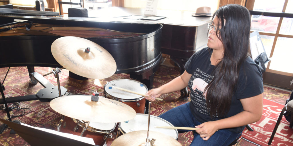 Woman plays the drums in the jazz ensemble