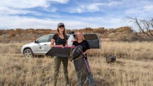 Katie Withnall and Patricia Dappen, GIS specialists with the New Mexico Forest and Watershed Restoration Institute, pose with a drone outdoors