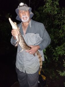 photo of scientist holding a caiman