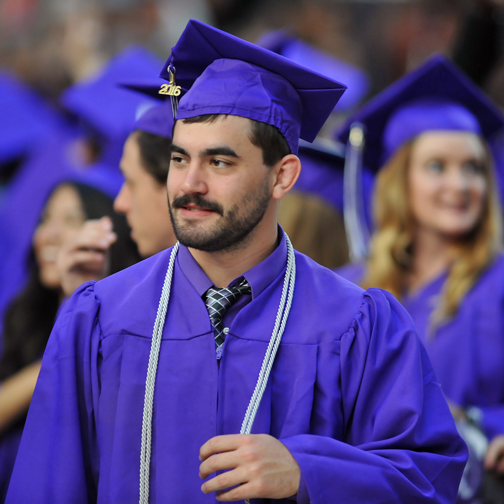 Graduate stands among his peers