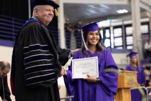 Photo of graduate with President Minner