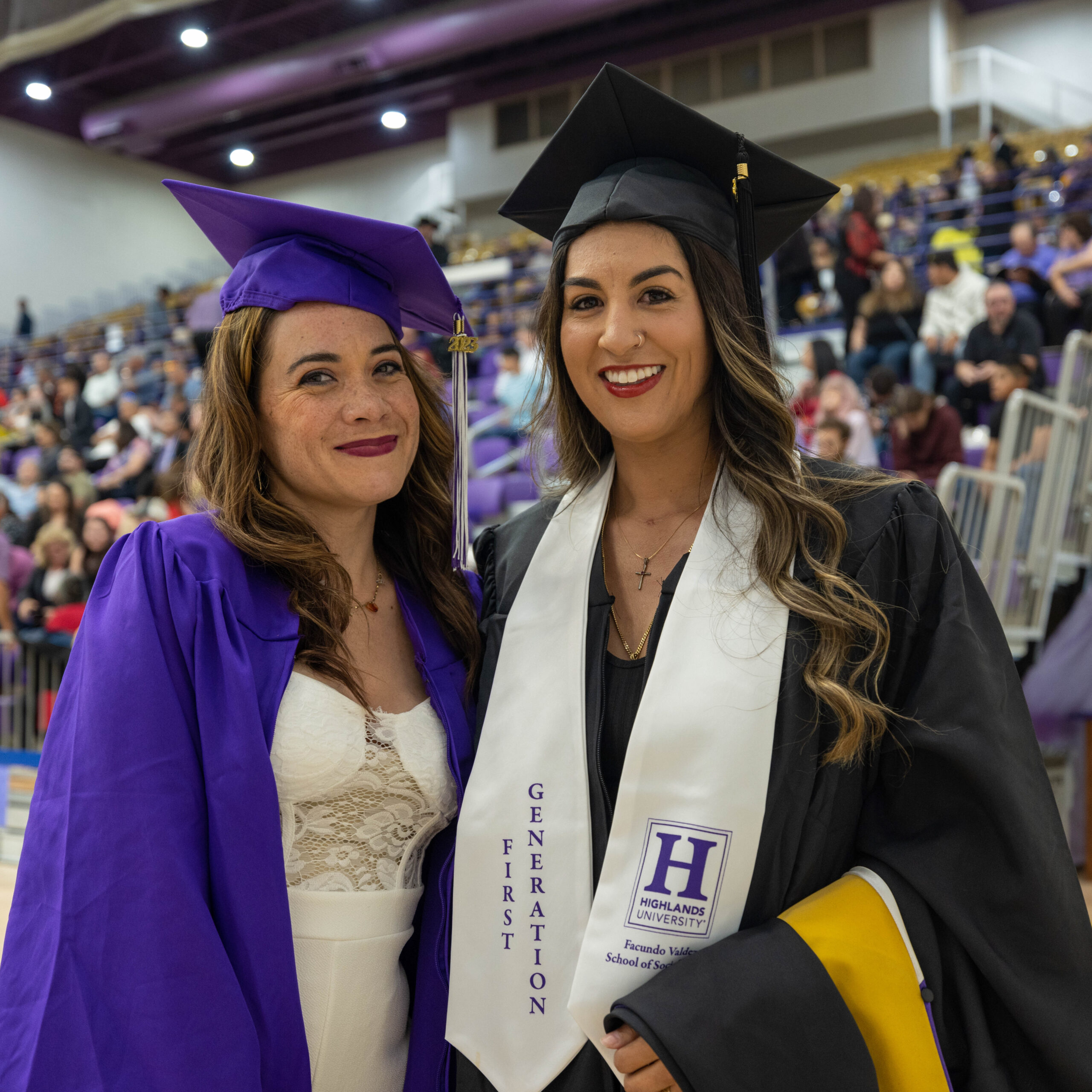 2023-commencement-12 Standing and smiling graduating students at 2023 Commencement Ceremony