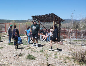 Image of students and faculty in the field.