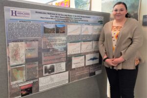 geology student poses with research about water quality